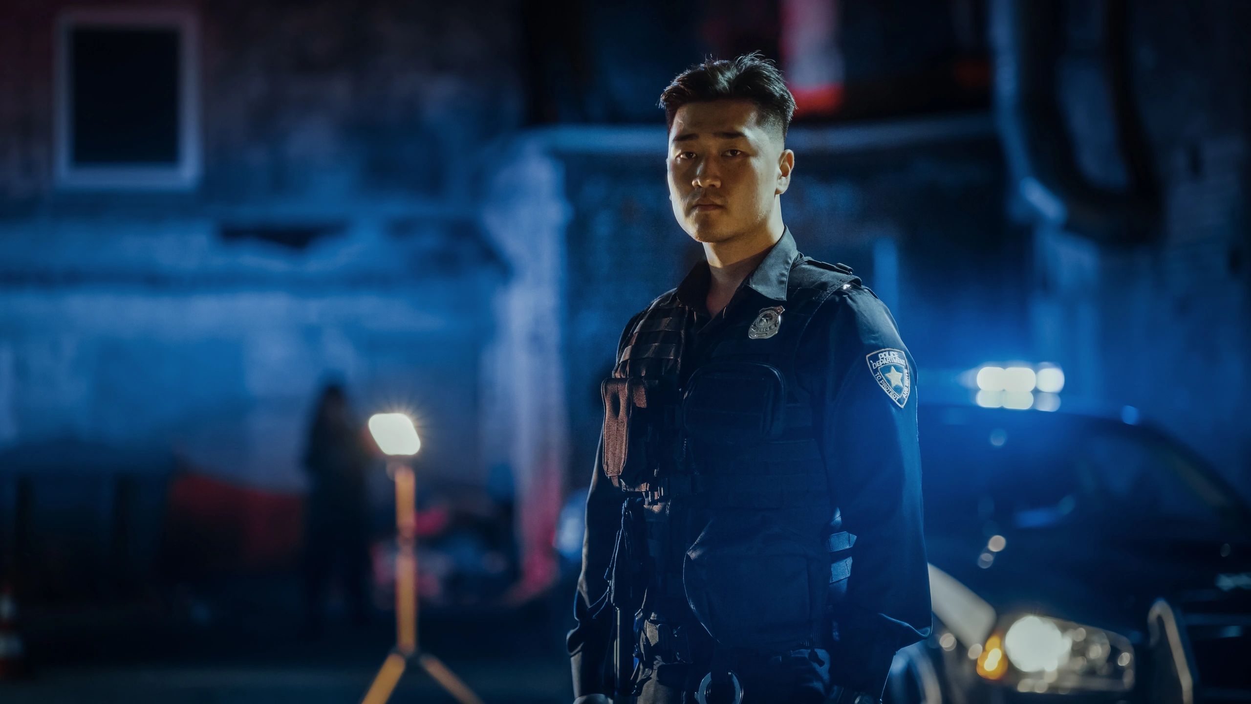 Uniformed police officer communicating by radio during patrol.