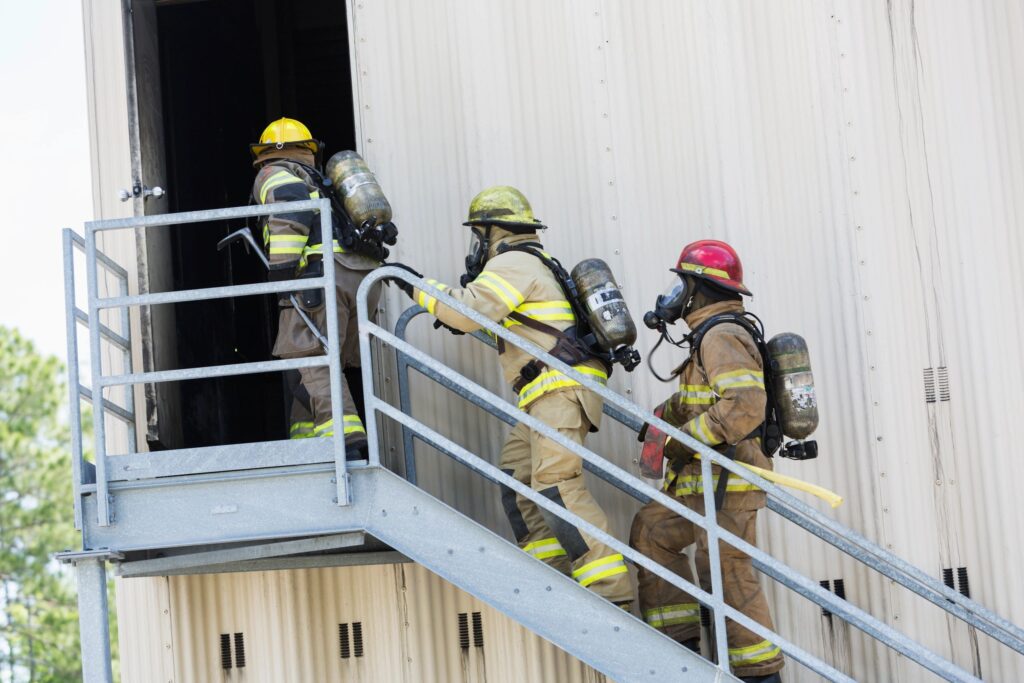 Firefighters ascending stairs during a training response.
